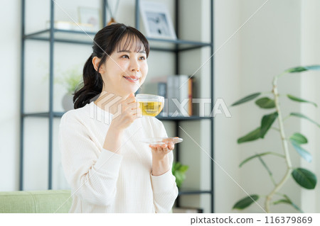 年輕女子在客廳喝涼茶 年輕女子在客廳喝涼茶 116379869