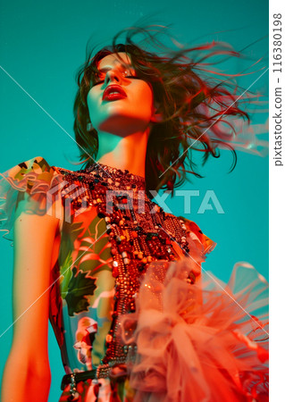 A woman in a floral dress with a red lipstick is standing in front of a blue sky A woman in a floral dress with a red lipstick is standing in front of a blue sky 116380198