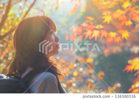 A woman staring at the autumn leaves 116380316