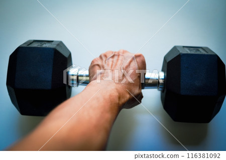 Close-up of a woman exercising with dumbbells Close-up of a woman exercising with dumbbells 116381092