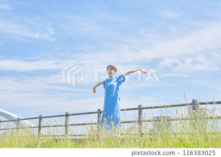 A woman stretching outdoors A woman stretching outdoors 116383025