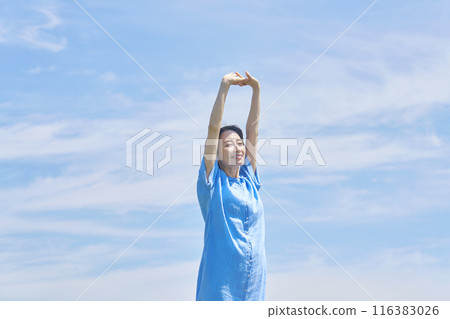 A woman stretching outdoors A woman stretching outdoors 116383026