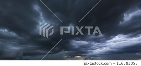 The dark sky with heavy clouds converging and a violent storm before the rain.Bad or moody weather sky and environment. carbon dioxide emissions, greenhouse effect, global warming, climate change 116383055
