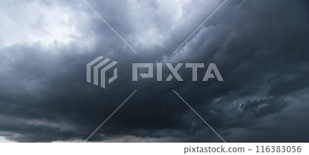 Bad or moody weather sky and environment. The dark sky with heavy clouds converging and a violent storm before the rain. carbon dioxide emissions, greenhouse effect, global warming, climate change 116383056