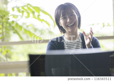 A woman relaxing at a cafe A woman relaxing at a cafe 116383511