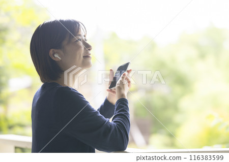 A woman operating a smartphone A woman operating a smartphone 116383599