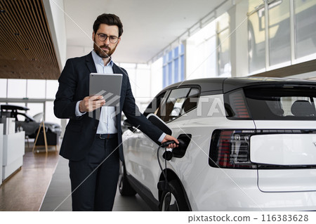 Dealer sells electric car in vehicle dealership 116383628