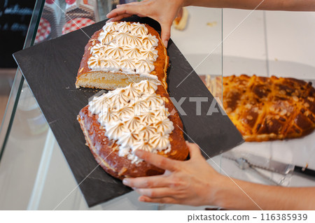 Traditional coke cut in two pieces in a bakery 116385939