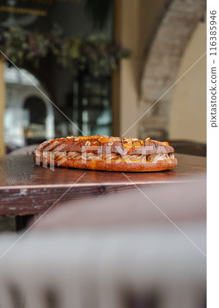 Chocolate cake and fruit on top of the dough on a bar terrace. Vertical 116385946