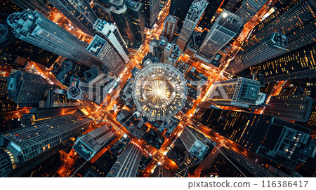 An aerial view of a busy city at night, bathed in a neon glow, with bustling streets forming a busy grid of city life 116386417