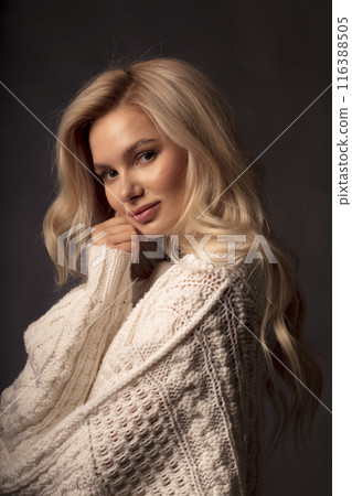 Portrait of a beautiful young blonde on a dark background, a photo of a young woman with long hair Portrait of a beautiful young blonde on a dark background, a photo of a young woman with long hair 116388505