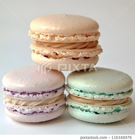 Stack of three delicious colorful macarons balancing on white background 116388976