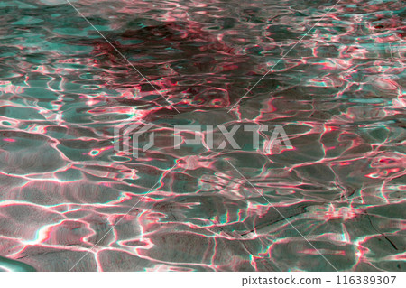 Sun glare on the water in the fountain with an old stone floor, unusual abstract texture 116389307