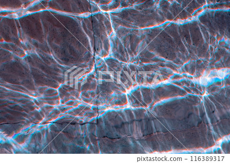 Sun glare on the water in the fountain with an old stone floor, unusual abstract texture Sun glare on the water in the fountain with an old stone floor, unusual abstract texture 116389317
