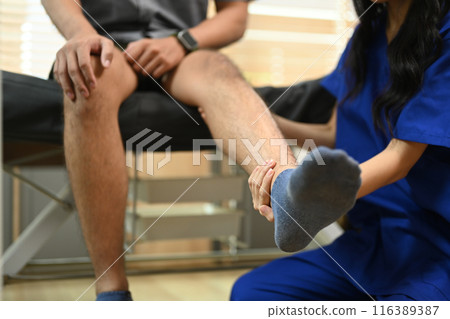 Physiotherapist examining patient in manual therapy clinic. Rehabilitation concept 116389387