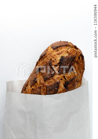 fresh bread in paper bag isolated on white background, top view 116390944