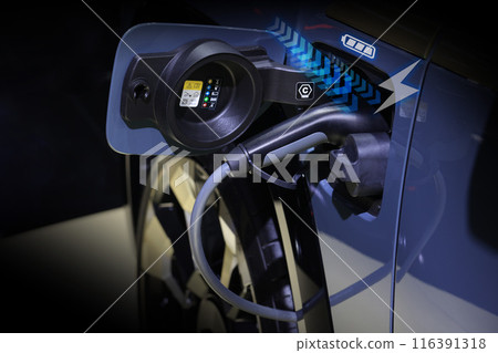 Power cable pump plug in charging power to electric vehicle EV car. 116391318
