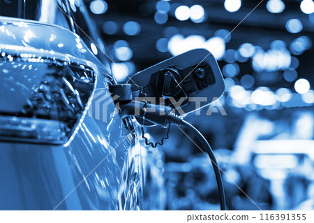 Power cable pump plug in charging power to electric vehicle EV car. 116391355