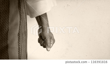 Man clenched his fist against a white wall Man clenched his fist against a white wall 116391816