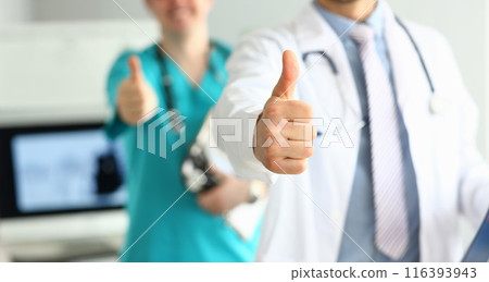 Two doctors show thumb up gesture with hands 116393943