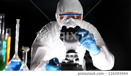 Male chemist in blue protective gloves look 116393944