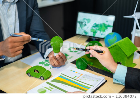 Businessman team brainstorming using tablet, laptop computer for working technology and business,  Renewable energy-based green businesses and global warming. Reduce CO2 emission. 116394072