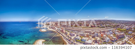 Drone panorama over the Italian city of Civitavecchia with harbor and cruise ships during the day Drone panorama over the Italian city of Civitavecchia with harbor and cruise ships during the day 116394107