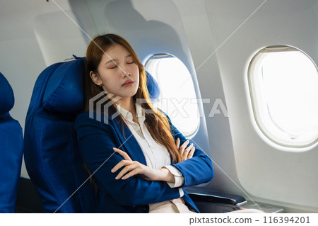 Tired asian woman with headache feeling sick while sitting in the airplane , Passengers near the window. 116394201