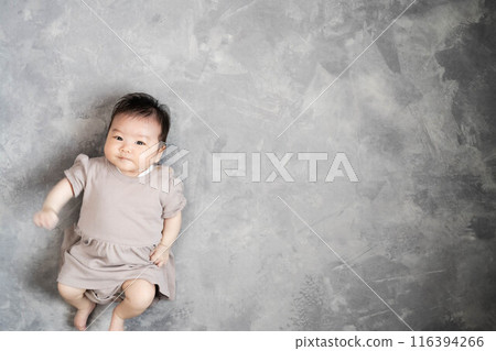 Baby sleeping on the floor on a grey background 116394266