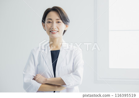 Smiling woman in a white coat Smiling woman in a white coat 116395519