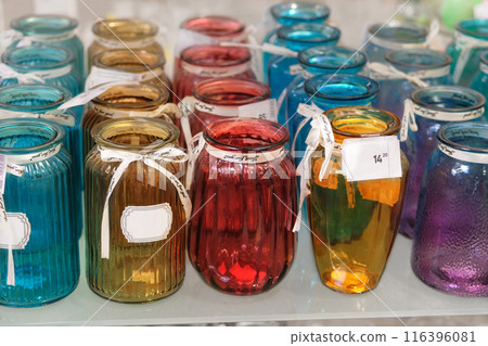 Colored glass vases are sold in shop. Jars for flowers. Colored glass vases are sold in shop. Jars for flowers. 116396081