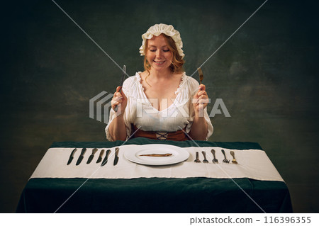 Smiling woman in historical clothes, with bonnet and white blouse sitting at table with multiple knives and forks, 116396355