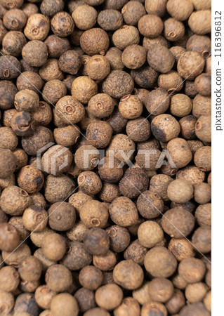 Black peppercorns top view macro close-up vertical. 116396812