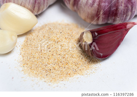 Ground dried garlic powder, natural spice, white background. Ground dried garlic powder, natural spice, white background. 116397286