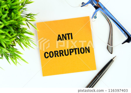 Anti money laundering business and government concept. ANTI CORRUPTION text. words on a yellow mustard flower sticker on a white background 116397403