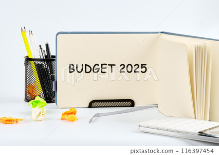 Conceptual budget 2025 symbol. Copy space. Budget 2025 words written in a notebook on a table on a light background Conceptual budget 2025 symbol. Copy space. Budget 2025 words written in a notebook on a table on a light background 116397454