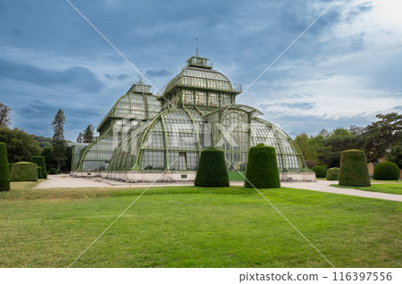 Vienna, Austria, August 20, 2022. In the gardens of Schonbrunn Palace, the historic greenhouse stands out for its characteristic design. Travel destinations. Copy space Vienna, Austria, August 20, 2022. In the gardens of Schonbrunn Palace, the historic greenhouse stands out for its characteristic design. Travel destinations. Copy space 116397556