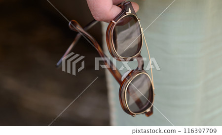 Sunglasses in hand Sunglasses in hand 116397709