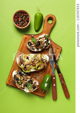 Sandwiches with grilled vegetables on a board, on a green background. Sandwiches with grilled vegetables on a board, on a green background. 116397833