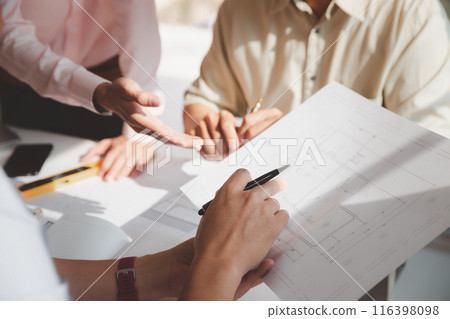Confident team of architect working together in a office.Then discussing about new startup project on desk. Architect discuss with engineer about project in office, architectural concept. 116398098