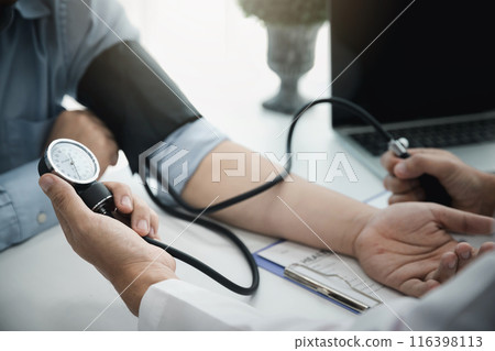 Doctor measuring blood pressure of the patient in the hospital, Medical and health care concepts. Doctor measuring blood pressure of the patient in the hospital, Medical and health care concepts. 116398113