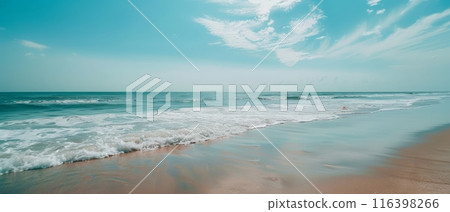 A tranquil beach under a clear sky, the gentle waves whispering to the sandy shore. The vastness of the sea mirrors the infinite blue above, evoking a sense of peace. 116398266