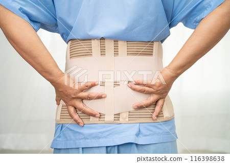 Asian lady patient wearing back pain support belt for orthopedic lumbar with walker. Asian lady patient wearing back pain support belt for orthopedic lumbar with walker. 116398638