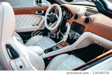 Showcasing a chic combination of cream and tan, this car interior photo captures the stylish upholstery and sleek design elements of a luxury vehicle. The image conveys a sense of modern elegance. 116398720