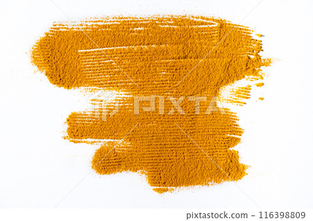 A smear of turmeric on a white background, top view A smear of turmeric on a white background, top view 116398809