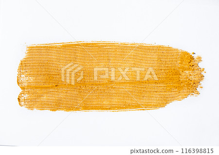 A smear of turmeric on a white background, top view A smear of turmeric on a white background, top view 116398815