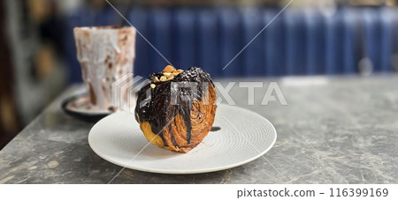 Delicious Cromboloni or Crombolini, croissant Bomboloni round New York Roll with Chocolate or caramel sauce pastry perfect for dessert recipe multimedia content 116399169