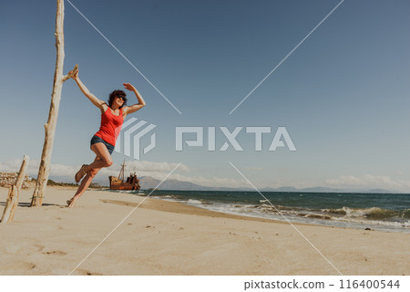 Tourist woman on beach enjoying vacation 116400544