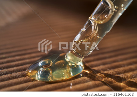 Pipette with serum on a corrugated surface. Pipette with serum on a corrugated surface. 116401108