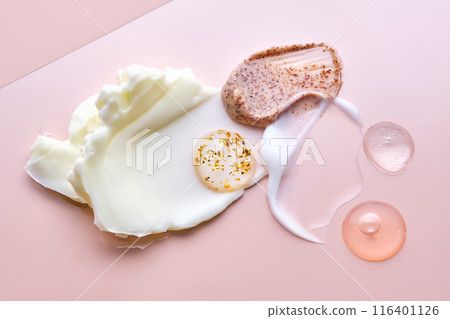 Different cosmetic textures on a delicate peach background.  116401126